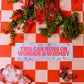 Decorative sign with flowers and butterfly on a red and white checkered background