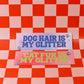 Two signs on a red and pink checkered background, one saying 'Dog hair is my glitter' and the other 'Cat fur is my glitter'.
