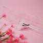 Close-up of a crystal car vent clip with pink flowers on a pink background