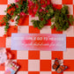 Checkered tablecloth with flowers, a card, a butterfly, and a box of matches on a red and white checkered background.