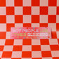 Pink sign with text on a red and pink checkered background