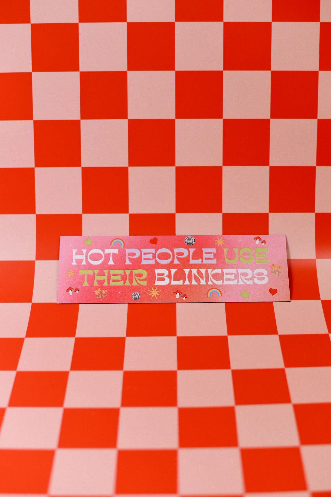 Pink sign with text on a red and pink checkered background