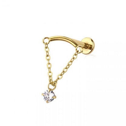 Gold earring with a chain and small gemstone on a white background, branded 'Crave'.